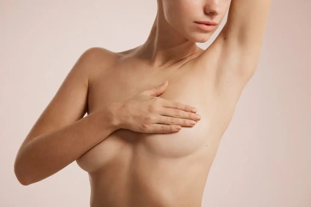 Woman with her hand across her chest