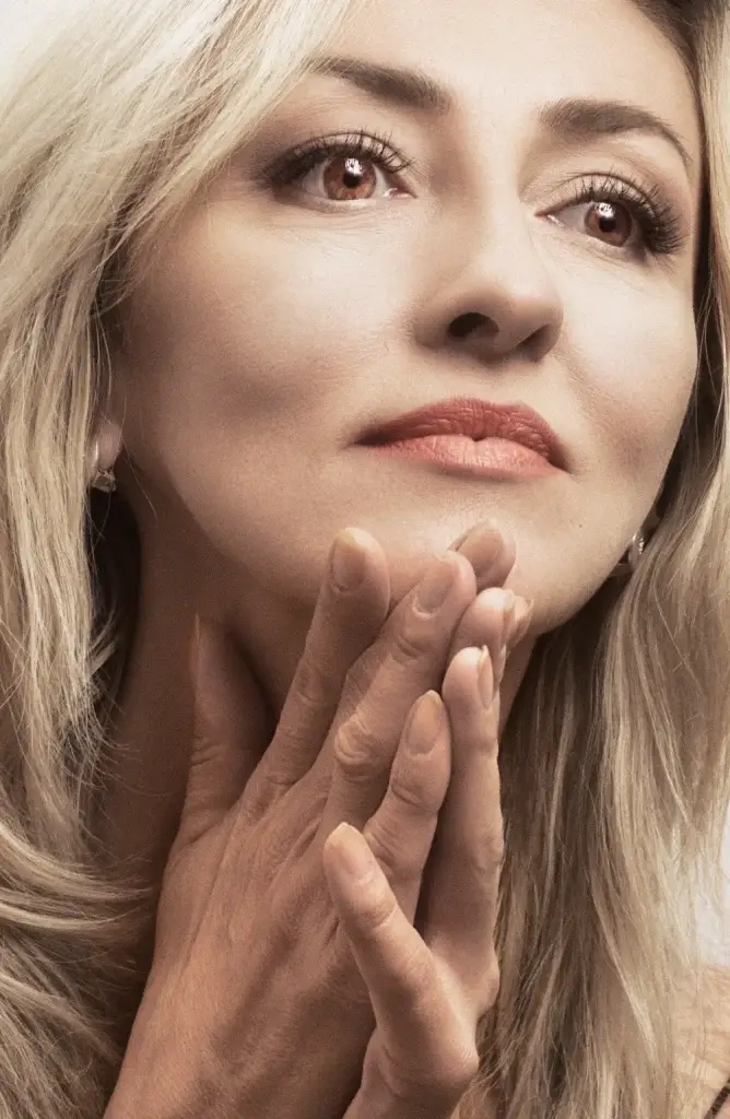 Woman with her hand along her jawline